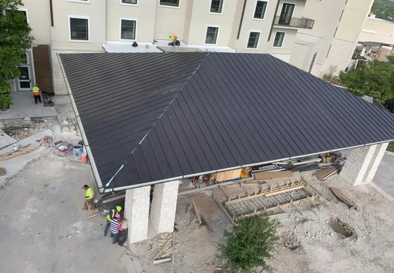 Metal roofing installation team working on a commercial building in Sitka