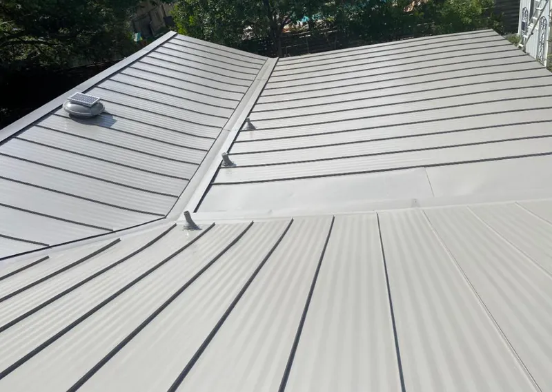 Solar attic fan installed on a metal roof for Roof Ventilation in Sitka